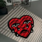 Perspective view of the Crying Heart traditional tattoo rug styled on a dark slate tile floor in a sunlit modern entryway, positioned next to a dark wood console table.