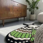 Low-angle perspective view of the Death Moth rug styled in a sunlit modern room on a grey floor, positioned next to a mid-century warm wooden dresser and a large green houseplant.