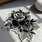 Perspective view of the Dual Rose black and white traditional tattoo rug resting on a smooth concrete floor, beautifully bathed in natural sunlight and shadows.