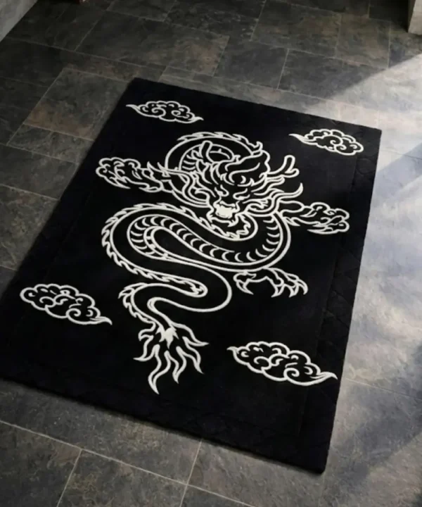 Angled view of the black and white Inferno Dragon Tattoo Rug, showcasing its rectangular shape and the striking contrast of the white dragon motif.