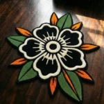 Flat top-down view of the Inked Garden Rug, clearly displaying the entire repeating traditional American tattoo flash pattern of red roses, blue accents, green leaves, and black dotted stars on a cream center, framed by a distinctive dark scalloped border with red trim.