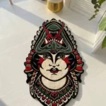 Top-down flat view of the Lady Face rug resting on a white floor in bright sunlight, perfectly showcasing its intricate neo-traditional tattoo flash design and colorful decorative collar details.