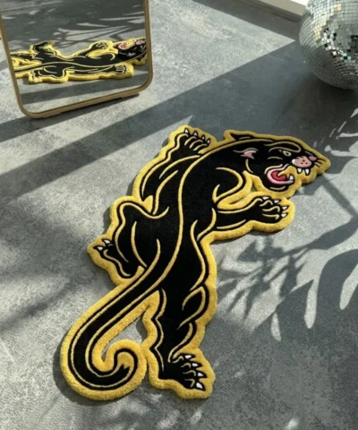 Close-up macro detail of the Neo-Traditional Panther rug, highlighting the dense hand-tufted New Zealand wool pile and the precise 3D carving of the panther's face, sharp teeth, red tongue, and yellow eye.