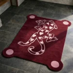 Perspective view of the rectangular Panther of Hearts rug on a dark slate floor, featuring a burgundy background, four pink circular corner extensions, and a bold pink hand-tufted panther motif patterned with hearts.