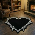 Wide perspective view of the black heart-shaped barbed wire rug in a warm den, surrounded by a wooden bookcase, a glowing floor lamp, a lit stone fireplace, and a brown leather armchair.