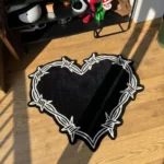 Perspective view of the black and white Sacred Heart barbed wire rug styled in a sunlit room on wooden floors, placed next to a black shelving unit holding helmets and pop culture decor.