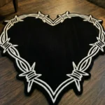 Angled perspective view of the Sacred Heart tattoo flash rug resting on dark hardwood floors in a cozy room near a classic lit stone fireplace.