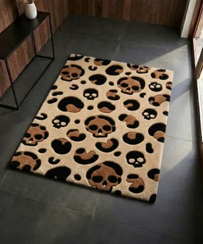 Perspective view of the rectangular Savage Skull Leopard rug styled on a dark slate floor, featuring a tan background with a unique leopard print pattern made of brown and black skulls and spots.