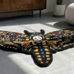 Wide perspective view of the Skull Death Moth rug styled in a sunlit modern room, resting on a smooth concrete floor next to a warm mid-century wooden dresser, a potted plant, and a textured white pouf.