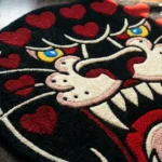 Close-up macro detail of the Wild Heart Panther rug, highlighting the dense hand-tufted wool pile and the crisp 3D carving of the panther's red mouth and sharp white teeth.