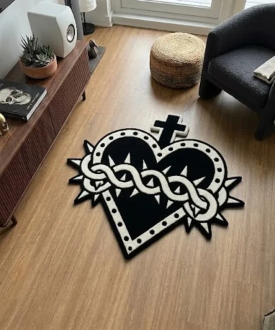 Gothic Sacred Heart hand-tufted rug in black and white styled on a wooden floor in a modern living room.