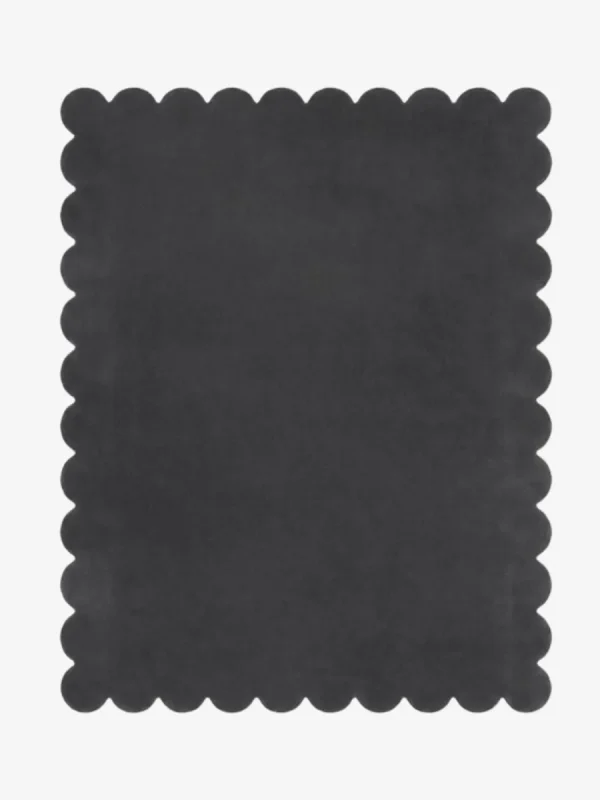 Top down view of the Aether Dior dark charcoal grey hand tufted wool rug on a white background showing the rectangular shape and scalloped edges.