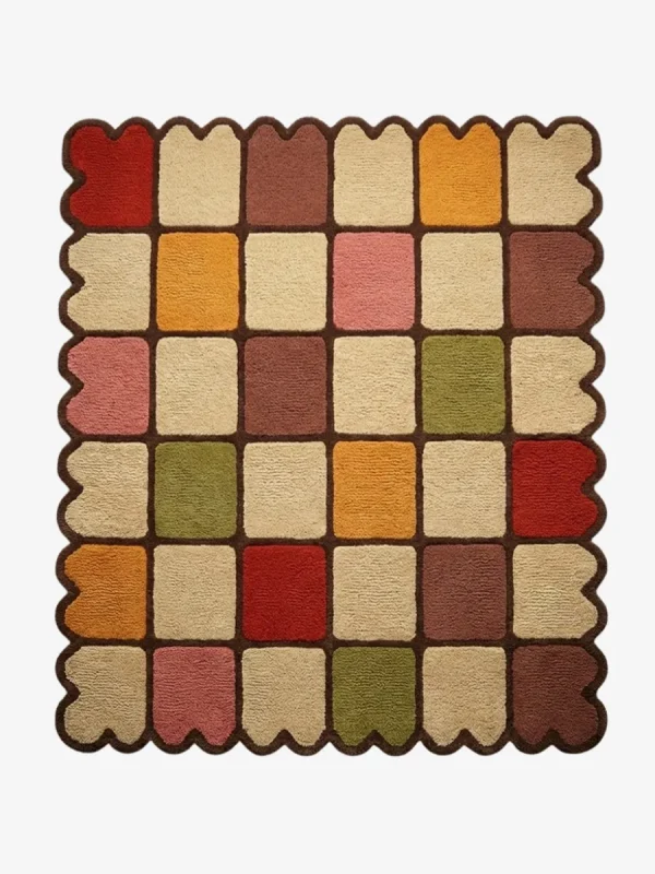 Top down view of the Autumn Tile Square rug featuring a vibrant checkered pattern in earthy red, mustard yellow, olive green, pink, and cream, finished with a dark brown grid and scalloped edge.
