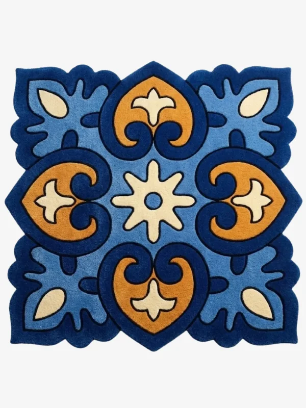 Top down view of the Azure Heirloom square rug featuring a traditional tile inspired geometric pattern with ornate blue and gold motifs and scalloped edges.