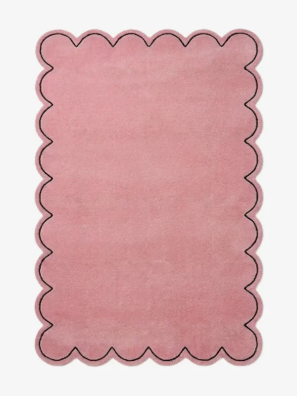 Top-down view of the rectangular Blush Halo rug, featuring a solid soft pink field with a continuous scalloped border and a thin black line outlining the wavy edge.