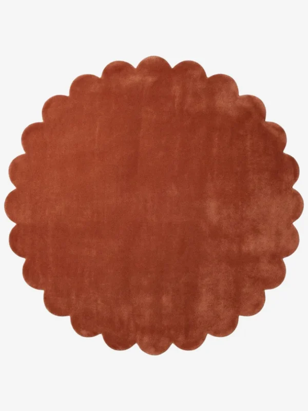 Top down flat lay of the Burnt Clay round wool rug showing the rich rust color and scalloped border.