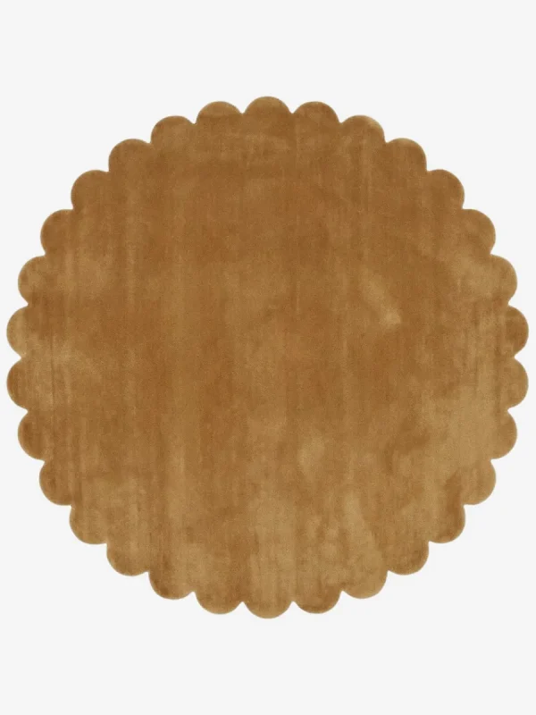 Top down view of the circular Camel Dawn golden tan hand tufted wool rug on a white background showing the scalloped border.