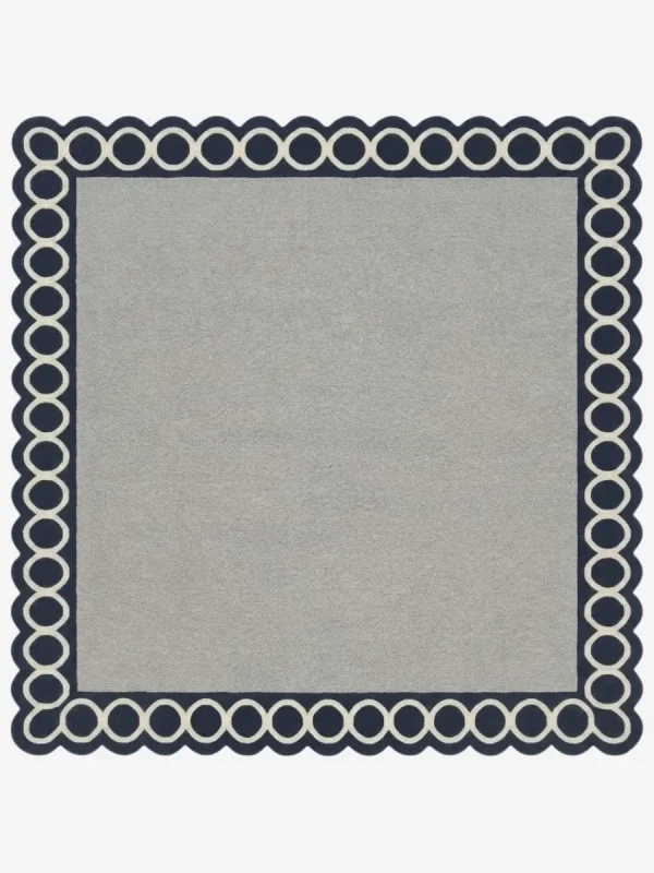 Top-down view of the Chain Frame square rug featuring a solid light grey center field framed by a bold navy blue border with interlocking white circular chain links.