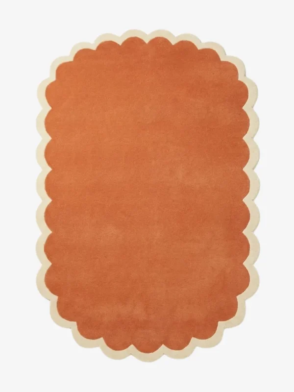 Top down view of the Clay Veranda rug featuring a rich, solid rust terracotta color center framed by a contrasting cream scalloped border.