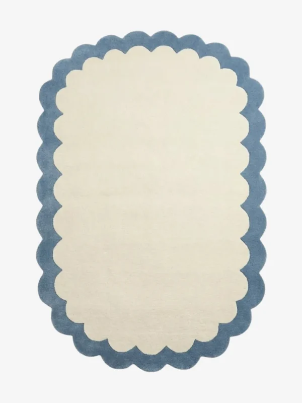 Top down view of the Cloud Marina rug featuring a soft cream center framed by a calming light blue scalloped border.