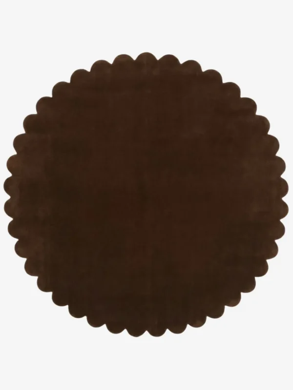 Top down view of the circular Cocoa Crest dark brown hand tufted wool rug on a white background showing the scalloped border.
