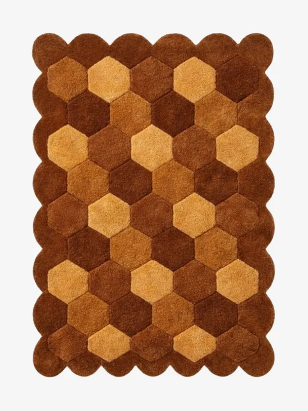 High angle view of the Cocoa Harlequin rug featuring a classic diamond checkerboard pattern in warm brown, tan, and cream wool tones, framed by a scalloped border.