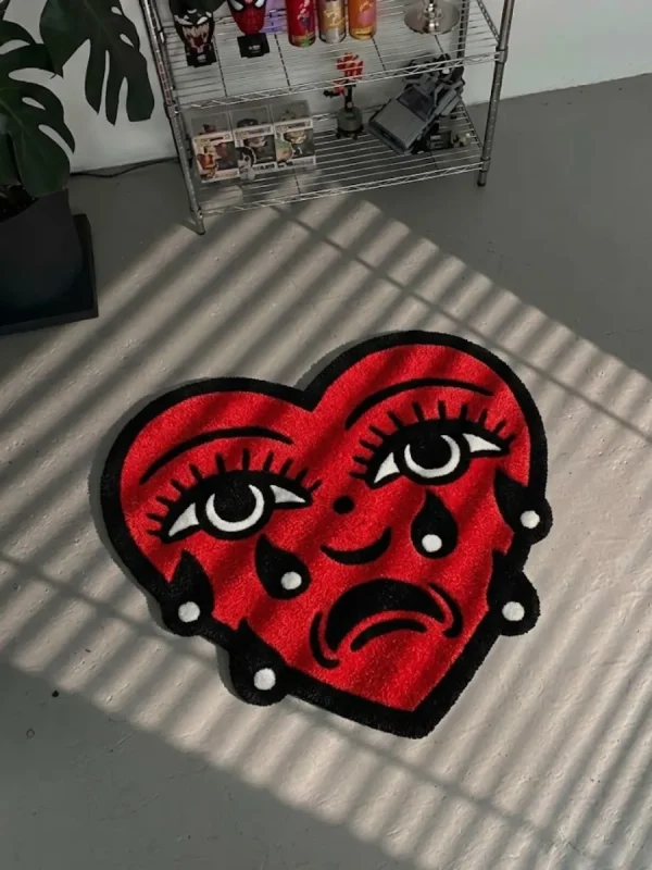 Perspective view of the Crying Heart traditional tattoo rug styled on a dark slate tile floor in a sunlit modern entryway, positioned next to a dark wood console table.