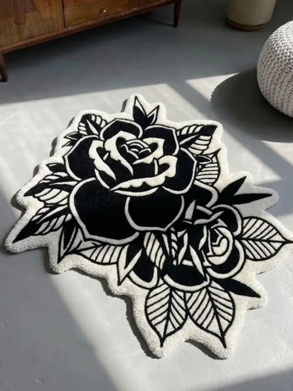 Perspective view of the Dual Rose black and white traditional tattoo rug resting on a smooth concrete floor, beautifully bathed in natural sunlight and shadows.