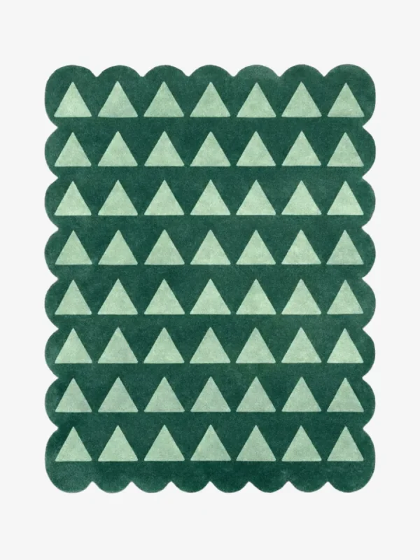 Top down view of the Emerald Steps rug featuring a repeating geometric pattern of light green U-shapes or steps on a deep emerald green wool background, finished with custom scalloped edges.