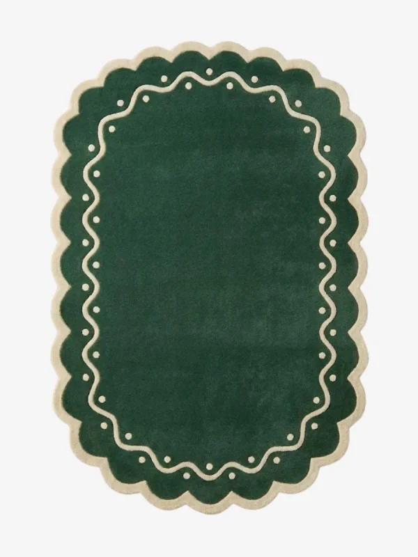 Top down view of the Emerald Veranda rug featuring a solid emerald green background with a decorative cream border containing wavy lines and polka dots.