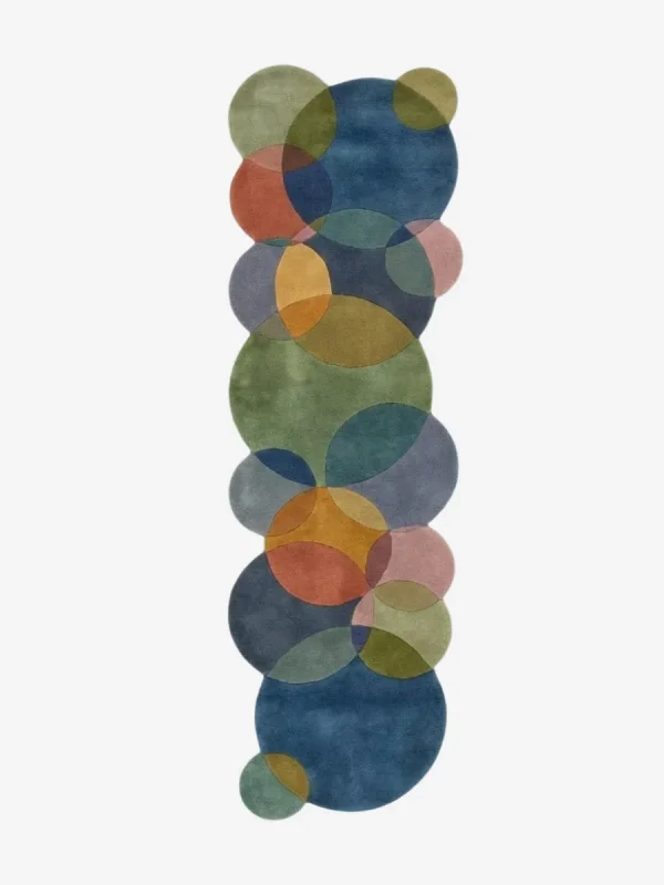 Top down view of the Eucalyptus Veil runner rug on a white background, displaying a modern abstract pattern of interlocking circles in calming pastel and earth tones with scalloped edges.