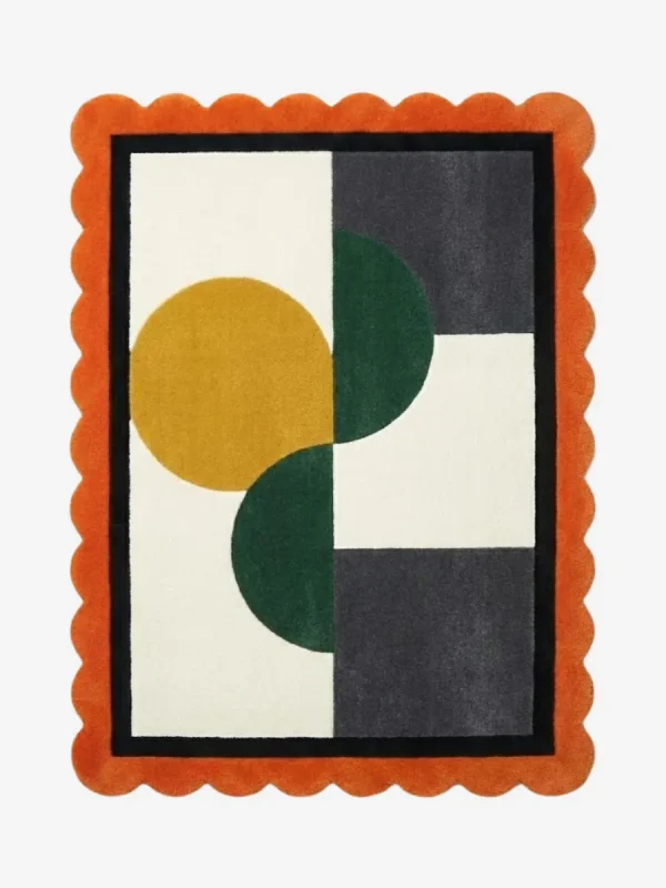Top-down view of the Everne Meadow hand-tufted wool rug featuring a vibrant orange scalloped border and a modern geometric block pattern with mustard yellow, deep green, and dark grey shapes on a cream background.
