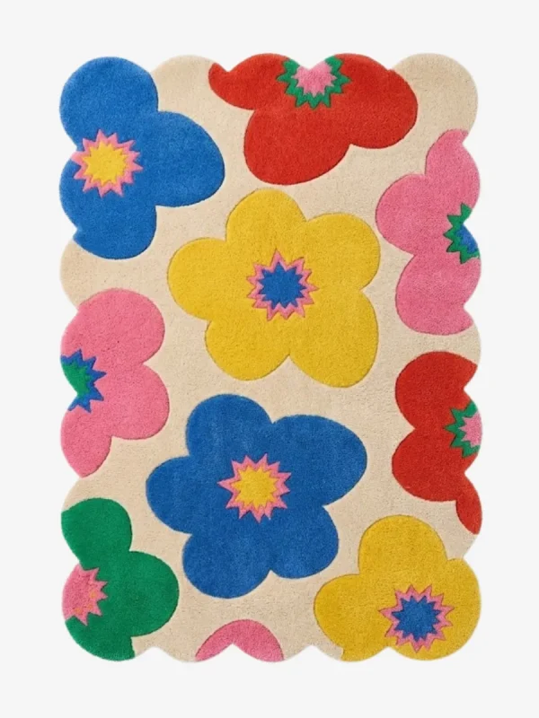 A vibrant and fun multicolor wool area rug with scalloped edges, perfect for adding a dopamine decor touch to a nursery or living space.