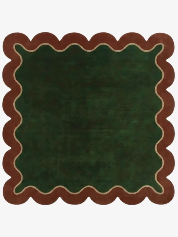 Top down view of the Forest Frame Square rug featuring a lush deep green central field framed by a wavy cream line and a rust-colored scalloped border.