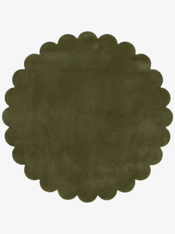 Top down view of the circular Forest Mirage green hand tufted wool rug on a white background showing the scalloped border.