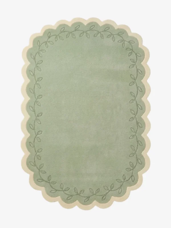 Top down view of the Garden Lace rug featuring a soft sage green center framed by a cream scalloped border with a delicate leafy vine pattern.