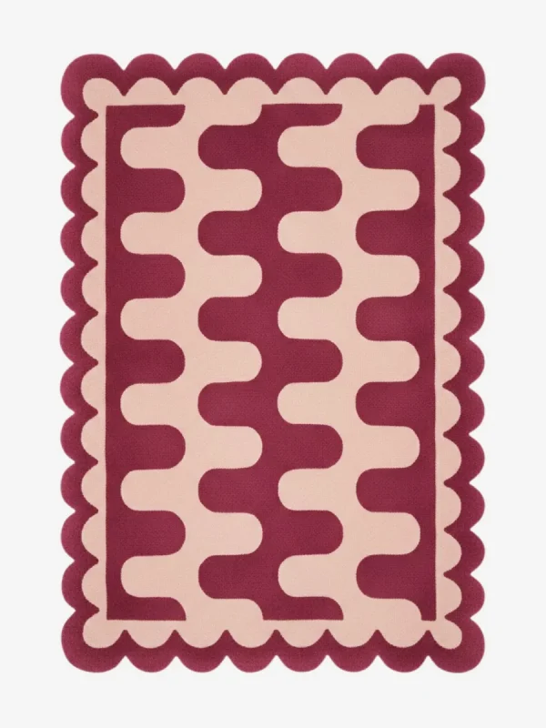 Top down view of the Garnet Loop rug featuring a rich maroon wool background with a bold cream wavy geometric pattern and custom scalloped edges.