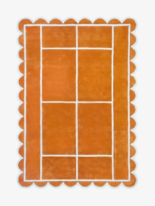 Top down view of the Hearth Grid rug featuring a vibrant terracotta orange wool background with a white geometric line pattern resembling a tennis court layout, finished with playful scalloped edges.