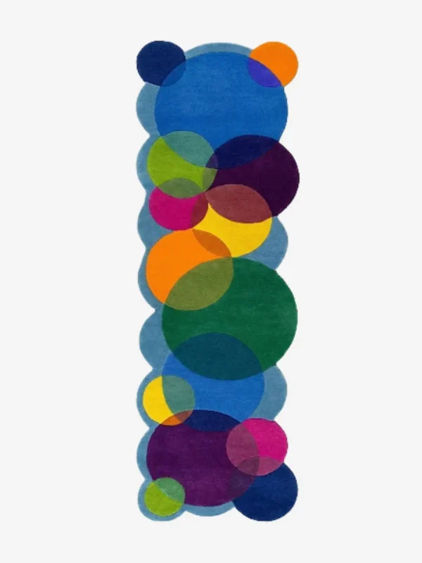 Top down view of the Indigo Carnival runner rug on a white background, featuring a bold geometric design of colorful interlocking circles and custom shaped edges.