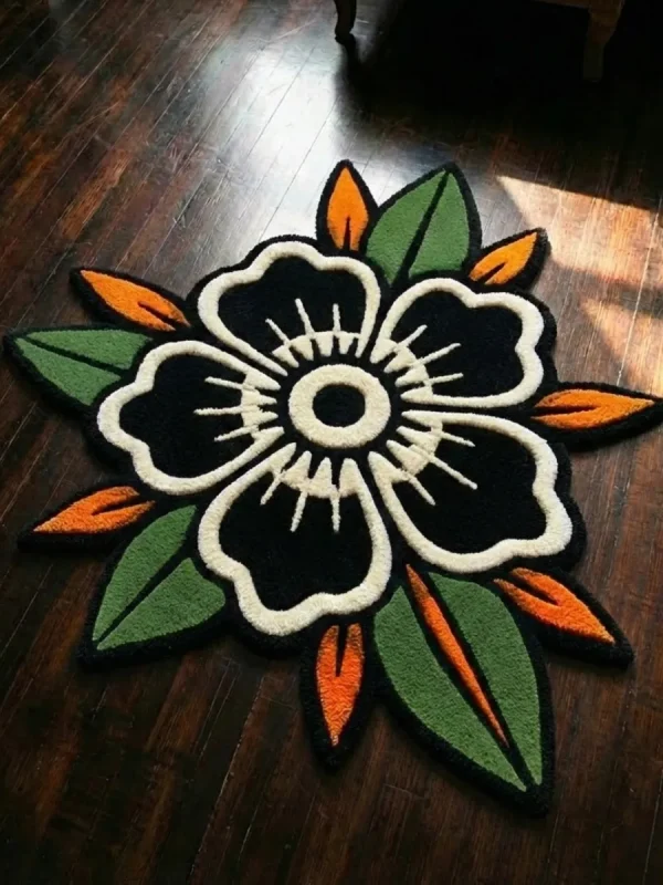 Flat top-down view of the Inked Garden Rug, clearly displaying the entire repeating traditional American tattoo flash pattern of red roses, blue accents, green leaves, and black dotted stars on a cream center, framed by a distinctive dark scalloped border with red trim.