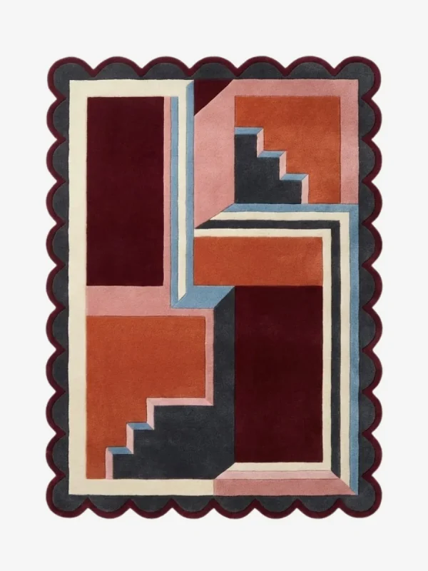 Top down view of the Inverse Staircase rug featuring a bold geometric design with an interlocking step pattern creating an optical depth effect, finished with custom scalloped edges.