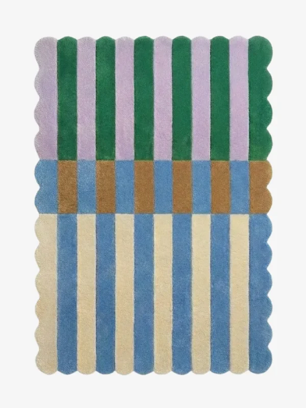 Top-down view of the Mint Gelato rug against a white background, featuring a vibrant color-block striped pattern with vertical bands of purple and dark green on the top half, a transitional band of brown and blue blocks in the center, and alternating cream and light blue stripes on the bottom half, all framed by a continuous scalloped border.