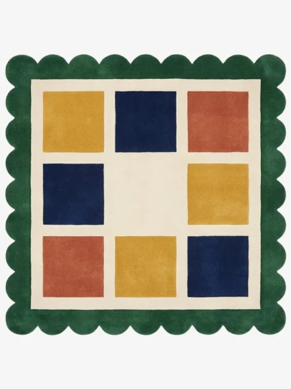 Top-down view of the square Mosaic Verve rug, featuring a cream grid with alternating colorful squares in mustard yellow, navy blue, and rust orange, all bordered by a thick forest green scalloped edge.