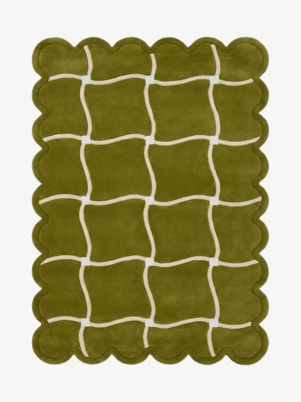 Top down view of the Moss Weave rug featuring a deep moss green wool background with a playful cream wavy grid pattern and custom scalloped edges.
