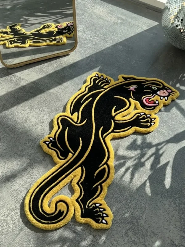 Close-up macro detail of the Neo-Traditional Panther rug, highlighting the dense hand-tufted New Zealand wool pile and the precise 3D carving of the panther's face, sharp teeth, red tongue, and yellow eye.