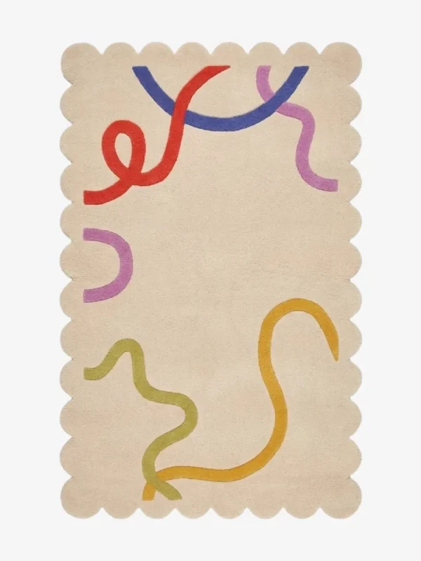 Top down flat lay of the Pastel Doodle rug featuring a soft cream background with playful abstract lines in red blue purple and yellow.