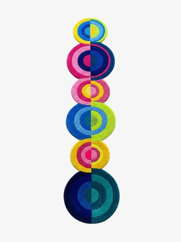 Top down view of the Pastel Pop Rings runner rug on a white background, featuring a playful vertical stack of concentric circles in varying sizes and bright pastel hues of pink, blue, yellow, and green.