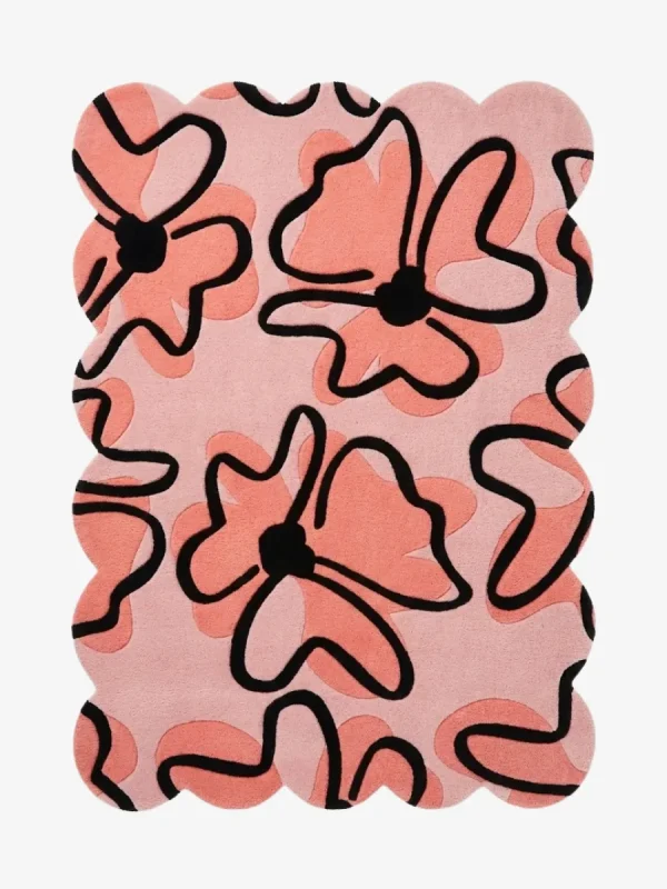 Top down view of the Peachy Sketch rug featuring a soft pink background with large abstract peach floral doodles outlined in bold black.