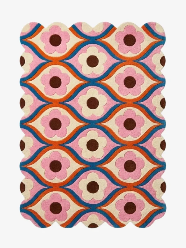 Top down view of the Petal Weave rug featuring a retro repeating floral pattern with pink flowers and blue wavy lines on a cream background.