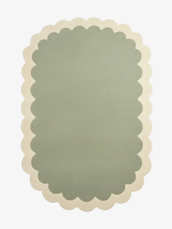 Top down view of the Pistachio Whale rug featuring a soothing ombre gradient design transitioning from sage green to soft cream, framed by a scalloped border.